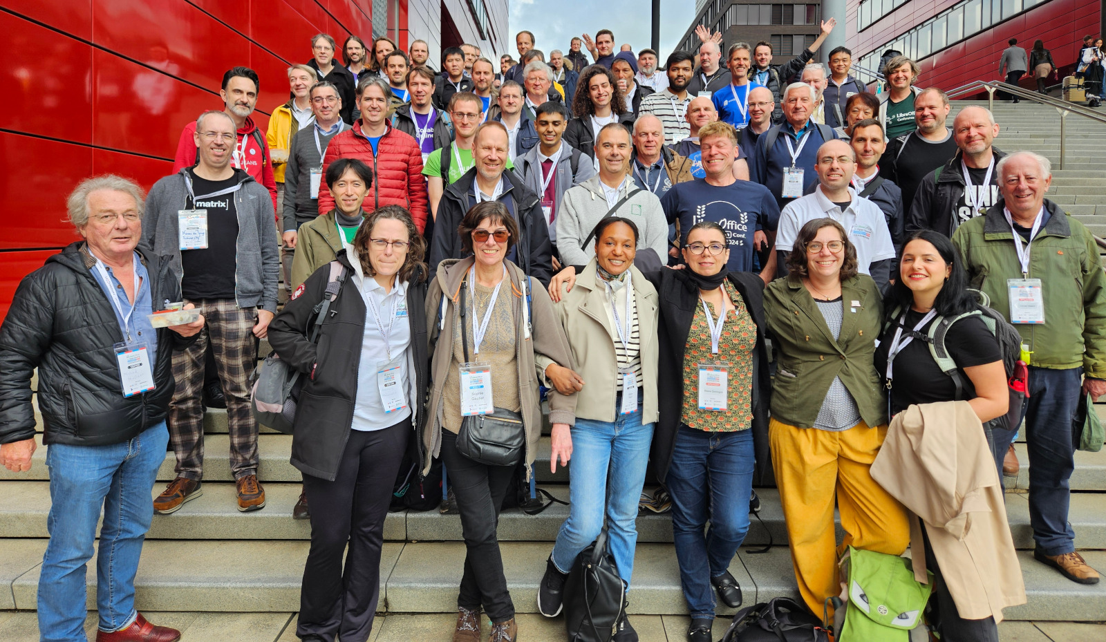 Photo of attendees standing on stairs in front of the venue